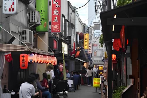 a group of people walking down a street with signs at Modern New House in Akabane Direct Access to Ikebukuro Shinjuku 新宿池袋赤羽 ## Shuttle, Ticket, Restaurant reservation service ## in Tokyo