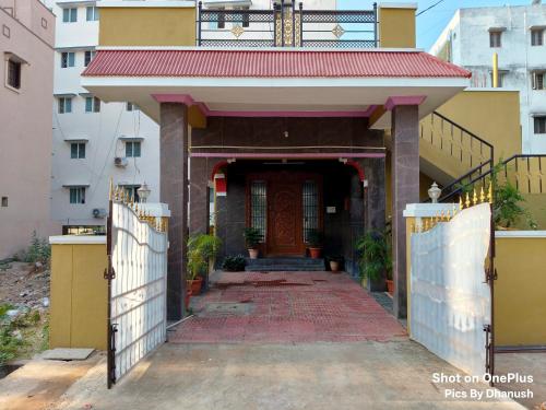 an entrance to a building with a red roof at Annamaiah Guest House & Homestay - Tirupati - Home Food Service in Tirupati