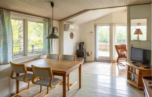 a dining room with a wooden table and chairs at 2 Bedroom Gorgeous Home In Hjørring in Hjørring
