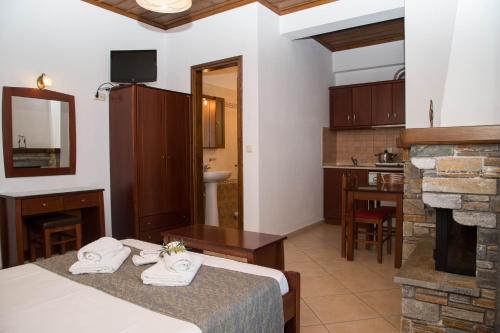 a hotel room with a bed and a fireplace at Guesthouse Enastron in Chorefto