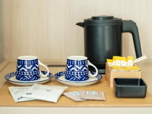 two blue and white cups and saucers on a table at HOTEL THE LEBEN OSAKA in Osaka