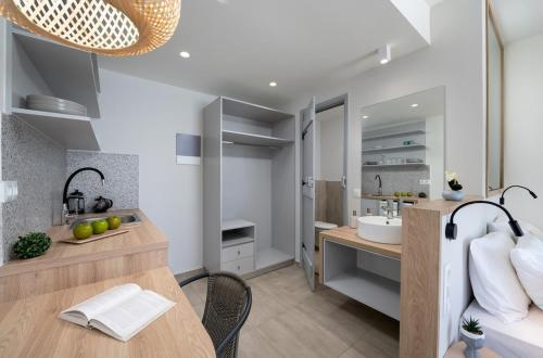 a bathroom with a sink and a vanity with a sink at Christine1 sea view studio WiFi in Elounda