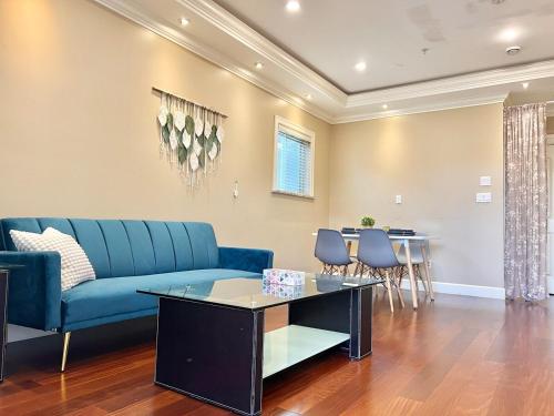 a living room with a blue couch and a table at Central & Comfy 1B1B in Vancouver