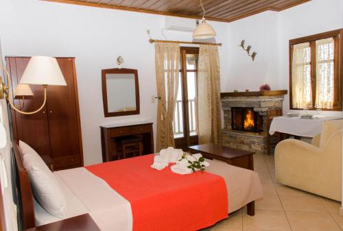 a hotel room with a bed and a fireplace at Guesthouse Enastron in Chorefto