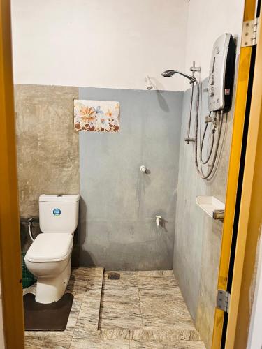 a bathroom with a toilet and a shower at Blue Mountains View in Dambulla