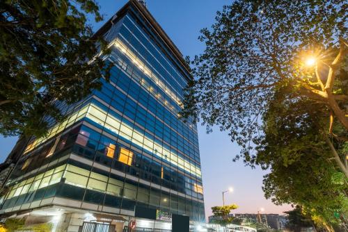 a tall glass office building at dusk at Treebo Vro Boutique, Andheri East in Mumbai