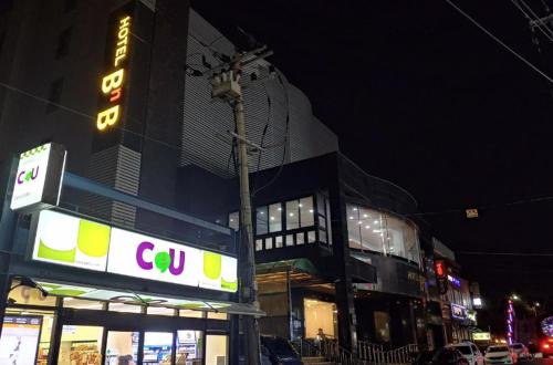 a building with a sign in front of it at night at Jeju BnB Hotel in Jeju