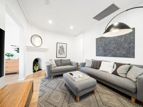 a living room with a couch and a table at The Mitchell Bondi in Sydney