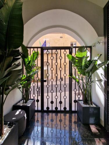 a hallway with a iron gate and plants at 1LoftMatera in Matera