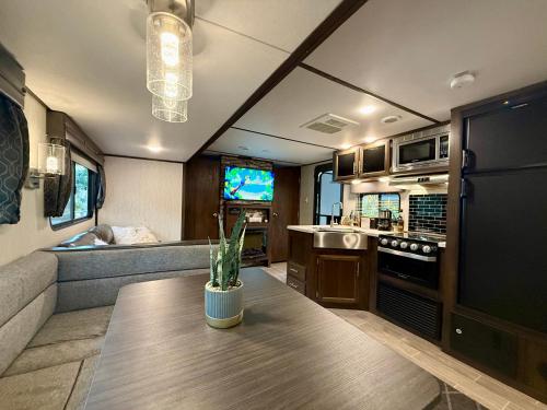 a kitchen and living room in a rv at Premium Glamping - Pool Waterslide Wi-Fi & Private Patio Lounge in Puerto Vallarta