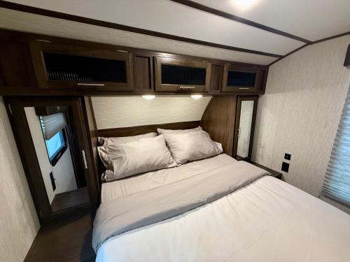 a small bedroom with a bed in an rv at Exclusive Glamping Resort Puerto Vallarta in Puerto Vallarta