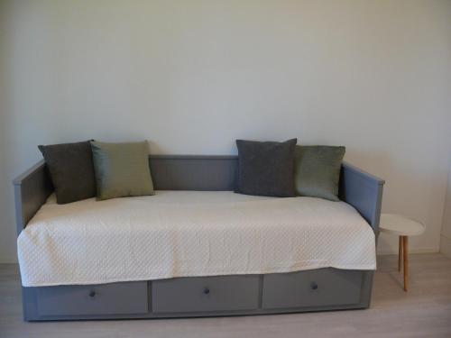 a bed with pillows on it in a room at Kerava Stay Studio in Kerava