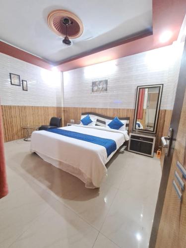 a bedroom with a large bed with blue pillows at HOTEL MANGALAM LUXUARY INN Near Railway station - A LUXUARY HOTEL in Lucknow
