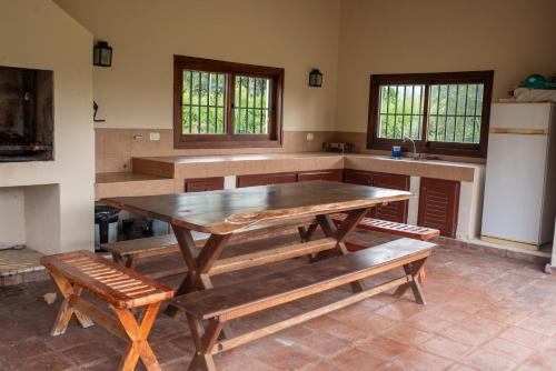 a kitchen with a wooden table and benches at La Casita en La Juni in San Javier