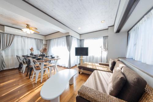 a living room with a couch and a table at UNITEDCUBE STAY TOKYO Private urban vacation home in Tokyo