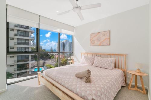 a bedroom with a bed and a large window at Sol Apartments Unit 604 in Gold Coast