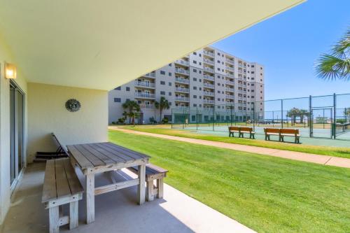 a picnic bench sitting on the porch of a building at Plantation Palms 6103 in Gulf Highlands