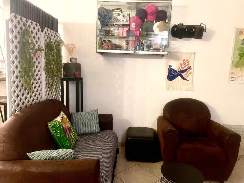 a living room with two chairs and a couch at Hôtel Colisée-Verdun Centre Gare Saint-Roch in Montpellier