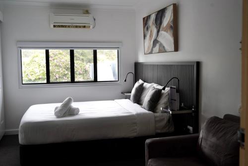 a bedroom with a large bed and a window at O'Shea's Royal Hotel in Goondiwindi