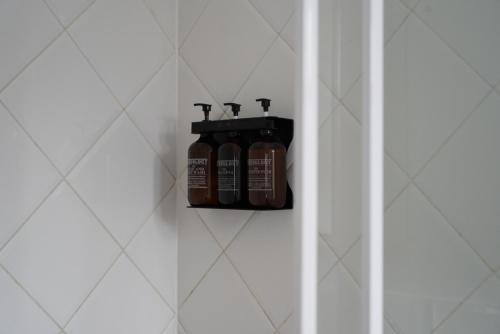 a shelf in a bathroom with two bottles at O'Shea's Royal Hotel in Goondiwindi