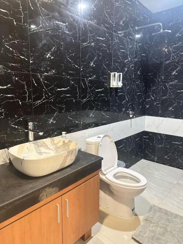 a bathroom with a sink and a toilet in it at 3BR Private Pool Villa Near Dreamland in Uluwatu