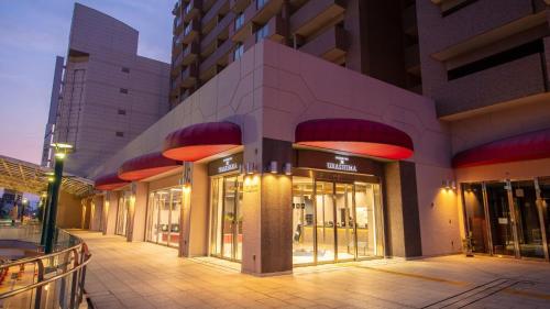 a building with glass doors on a street at STATION INN the URASHIMA in Onomichi