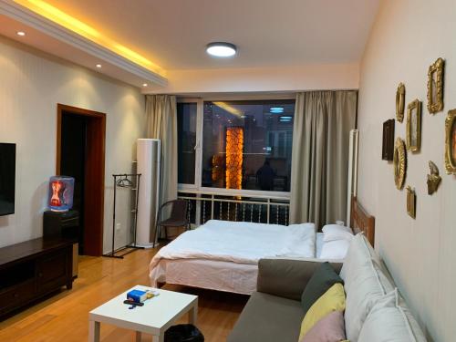 a living room with a bed and a couch at Beijing city center - Cosy family suite with city view in Beijing
