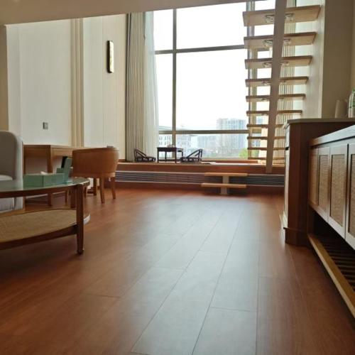 a living room with a couch and a table and a television at Wingate by Wyndham Libo Center in Libo