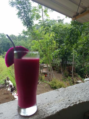 a drink in a glass sitting on a table at are twin bungalows in Tetebatu