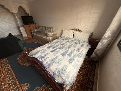 a bedroom with a bed and a chair at Julie Airport Boarding Apartment in Marrakech