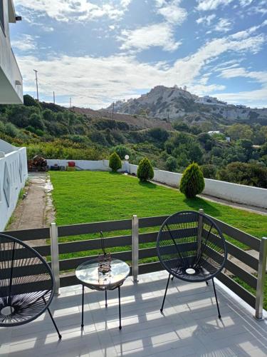 two chairs and a table on a balcony with a view at Alora House 2 in Kefalos