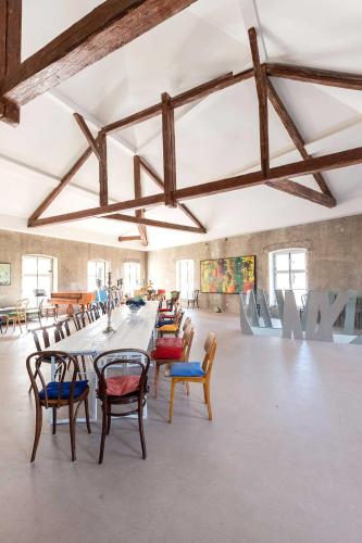a large room with a long table and chairs at Schloss Hollenburg Aparte Apartments in Krems an der Donau