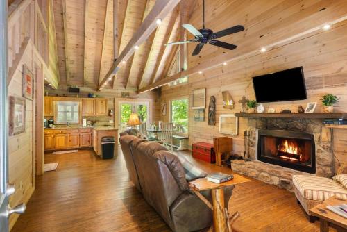 a living room with a couch and a fireplace at JW Hidden Lakes in Ellijay