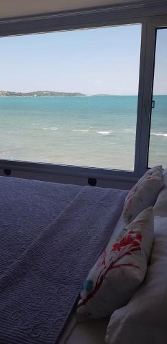 a bedroom with a bed with a view of the ocean at FOX Resort Hotel in Itʼkhvisi