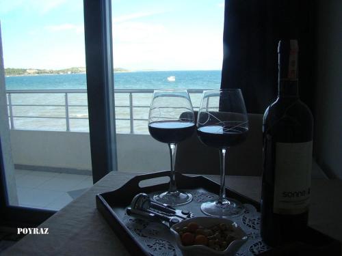 a tray with two glasses of wine and a bottle at FOX Resort Hotel in Itʼkhvisi