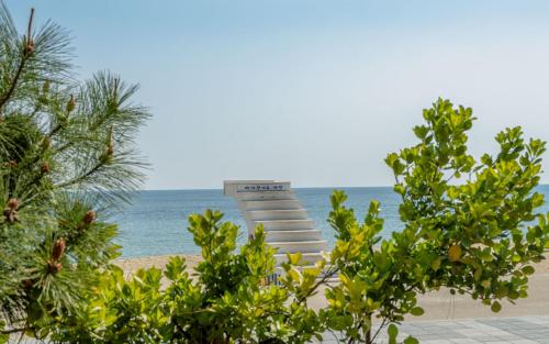 a monument on the beach with the ocean in the background at THE OCEAN Pension in Sokcho