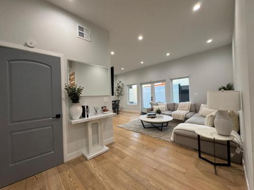 a living room with a couch and a table at Newly constructed 2 bedroom by La Cienega Plaza with parking, modern kitchen, washer dryer and very central to attractions in Los Angeles