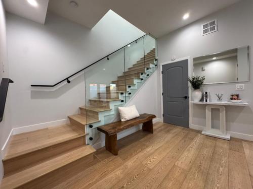 a staircase in a house with a bench and a stair case at Newly constructed 2 bedroom by La Cienega Plaza with parking, modern kitchen, washer dryer and very central to attractions in Los Angeles