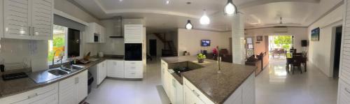 a large kitchen with a sink and a counter at Island Charm of Praslin in Victoria