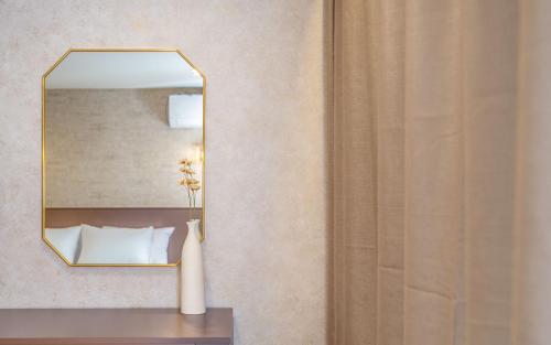 a hotel room with a mirror and a bed at THE OCEAN Pension in Sokcho
