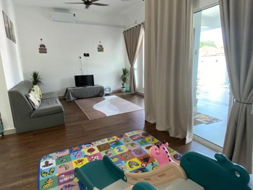 a living room with a childs bed in the middle of the room at Sarah Homestay in Kuala Terengganu