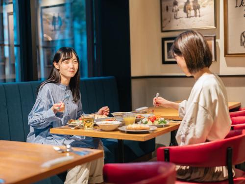 two women sitting at a table eating food at Keio Prelia Hotel Kyoto Karasuma-Gojo in Kyoto