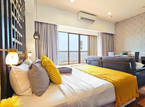 a bedroom with a large bed with a window at Sunway Studio HomeStay Access Mall & next to Lagoon by Cloud Host in Petaling Jaya