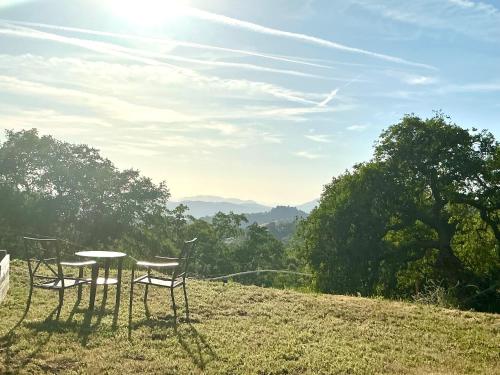 two tables and chairs sitting on top of a hill at Sequoia vacation home in Baker and Hall Airport