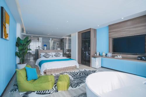 a large bedroom with a bed and a tv at Dali Mermaid Seascape Resort Hotel in Dali