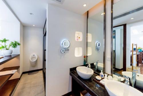 a bathroom with two sinks and a mirror at Dali Mermaid Seascape Resort Hotel in Dali