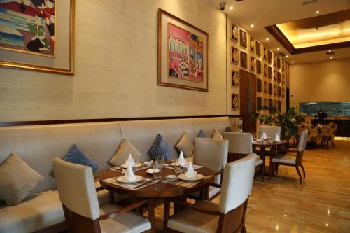 a restaurant with tables and chairs and a wall with pictures at Wyndham Chongqing Yuelai in Chongqing