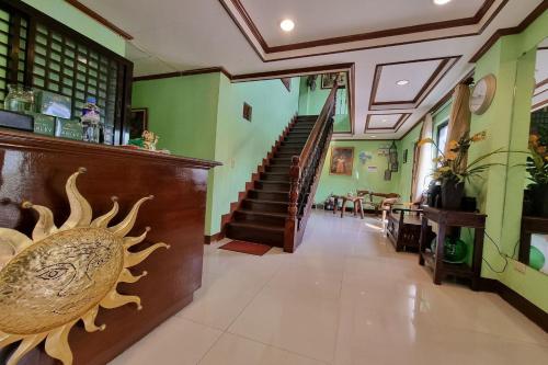 a hallway with a staircase in a house at Mojica Residencia Hotel in Vigan