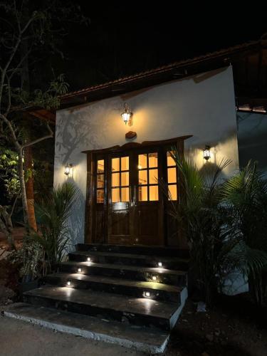a front door of a house at night at Lar Amorosa Boutique Hotel - Goa in Calangute