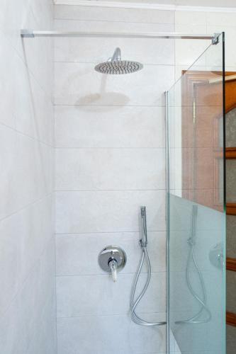 a bathroom with a shower with a glass door at Casa Maggio in Roccalumera